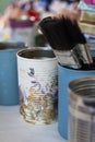 Upcycled tin cans and paint brushes Royalty Free Stock Photo