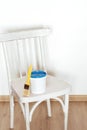 Upcycling concept. Old wooden retro chair, paint and brush, copy space. Preparation for painting chair