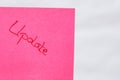 Update handwriting text close up isolated on pink paper with copy space. Writing text on memo post reminder