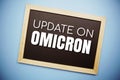 Update on OMICRON text on blackboard flat lay on blue background Royalty Free Stock Photo