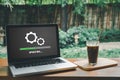 Person waiting for installing update process with loading bar icon on virtual screen on laptop computer