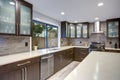 Updated contemporary kitchen room interior in white and dark tones.