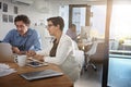 Updating each other on the projects progress. businesspeople working on a laptop in an office. Royalty Free Stock Photo