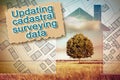 Updating public cadastral digital databases and information about land registry - concept with an imaginary cadastral map of Royalty Free Stock Photo