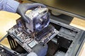 Upgrade or PC assembly concept. Technician installs a new motherboard with a large CPU cooler in a computer case Royalty Free Stock Photo