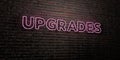 UPGRADES -Realistic Neon Sign on Brick Wall background - 3D rendered royalty free stock image