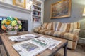 Multiple newspapers on coffee table and couch