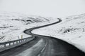 Uphill road landscape in winter at Iceland. Asphalt road with sideways full of snow Royalty Free Stock Photo