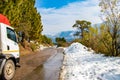 Uphill road in winter at banikhet dalhousie himachal pradesh india with sideways full of snow Royalty Free Stock Photo