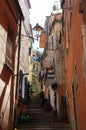 An uphill street in Monterosso. Flight of steps winding between two rows of colourful houses