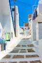 Uphill street with old white houses in Mykonos