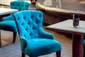 Upholstered armchair with fabric covering.