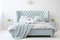 Upholstered bed in a luxurious bedroom in soft blue and gray tones