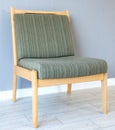 Upholstered furniture chair on a background of gray wall. Interior.