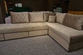 Upholstered furniture displayed for sale in the showroom of furniture store. Modern stylish sofas, couches and settees with bright