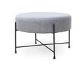Upholstered round gray footstool Royalty Free Stock Photo