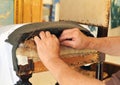 Upholsterer repairing the seat of a chair Royalty Free Stock Photo