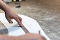 Upholsterer& x27;s hands painting leather parts with a pencil and a rule to repair a seat