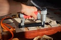 Working in upholstery workshop with pneumatic stapler. Royalty Free Stock Photo