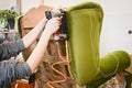 Woman working in upholstery workshop with pneumatic stapler. Royalty Free Stock Photo
