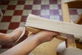 Woman working in upholstery workshop with webbing stretcher. Royalty Free Stock Photo