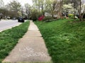 An uplifting message of Life is Good written on the sidewalk of a neighborhood during the COVID-19 pandemic; emtpy streets;