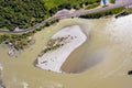 Upper aerial view of the Katun river in the Altai mountains, Russia with an asphalt road along which cars ride along a forest with