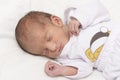 Upper body portrait of a newborn baby peacefully slept in bed