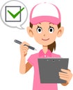 The upper body of a woman wearing a pink polo shirt and hat, filling in a check sheet Royalty Free Stock Photo