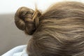 Upper bun close-up on brunette hair of a woman