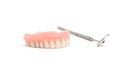 Upper dentures and dental mirror on white background Royalty Free Stock Photo