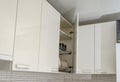 An upper kitchen cabinet with an open door Royalty Free Stock Photo
