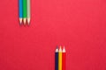 Upper and Lower Rows of Multicolored Pencils in Parallel Position Bottom and Top on Dark Red Paper Background. Business Creativity