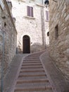 The upper narrow street in the medieval town of Assisi. Italy, August 2012