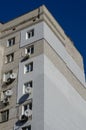 The upper part of an apartment building with many satellite dishes and air conditioning Royalty Free Stock Photo