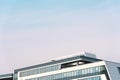 The upper part of the city office building against the blue sky, urban architecture