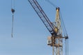 The upper part of the crane against the blue sky