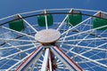 Upper part of ferris wheel with green and blue bowls Royalty Free Stock Photo
