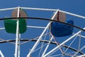 Upper part of ferris wheel with green and blue bowls. Royalty Free Stock Photo