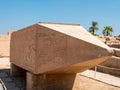 The upper part of the obelisk with Egyptian hieroglyphs and ancient drawings in the Karnak temple. Luxor, Egypt Royalty Free Stock Photo