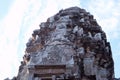The upper part of one of the towers of the Angkor temple complex. The architectural art of the ancient Khmer Royalty Free Stock Photo
