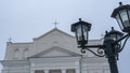 The upper part of the street lights in the old style on the background of the dome of the Catholic church