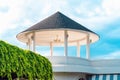 The upper part of the tiled gazebo rotunda. Beautiful dome made of concrete. Pointer to cardinal points on roof. Construction Royalty Free Stock Photo