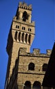 Upper part of the tower of Palazzo Vecchio in Florence, viewed from the south and silhouetted in the blue sky. Royalty Free Stock Photo