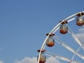 Upper quadrant of a ferris wheel against blue sky