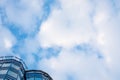 Upper section of a modern building with glass facade, blue sky Royalty Free Stock Photo