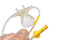 Upper side of mouth piece with nostrills of capnography sidestream patient monitor held in doctor left hand in sterile latex glove