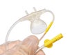 Upper side of mouth piece with nostrills of capnography sidestream patient monitor held in doctor left hand in sterile latex glove