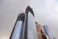 Upper stages of Moscow City towers under construction. Cloudy autumn view.