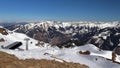 Upper station of the cable car. Alpine landscape at the end of winter. Blue sky, sunny day, spring in the mountains is coming. Royalty Free Stock Photo